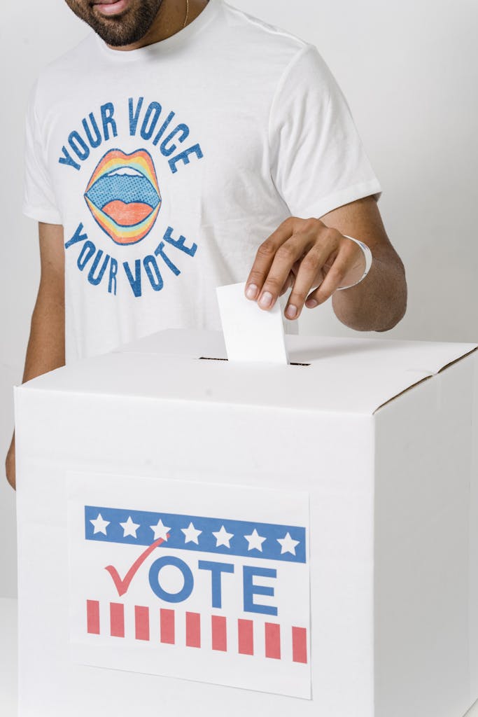 A Person Dropping His Vote in White Box