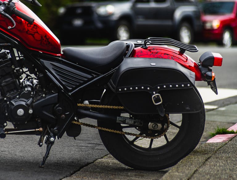 A red motorcycle parked on the side of the road
