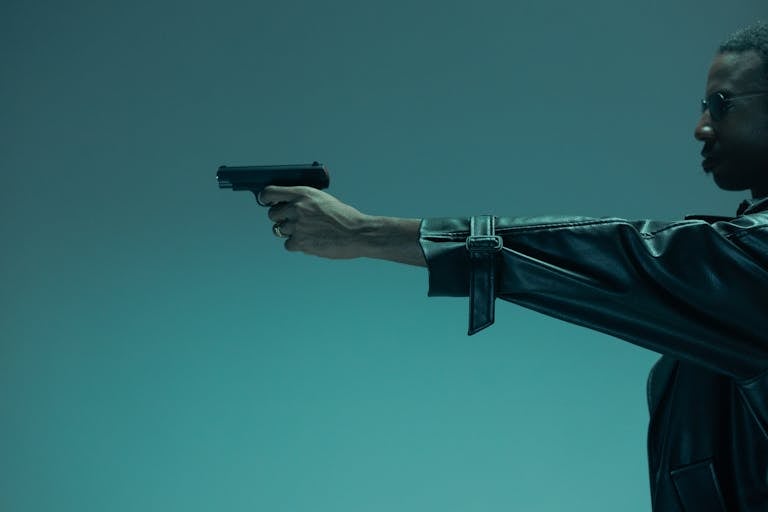 Person Holding Black Semi Automatic Pistol