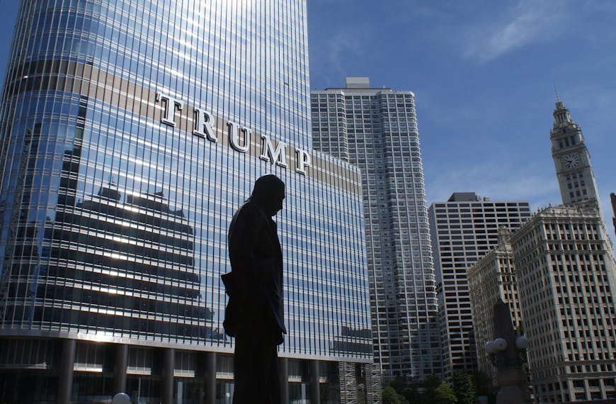 Silhouette of Statue Near Trump Building at Daytime