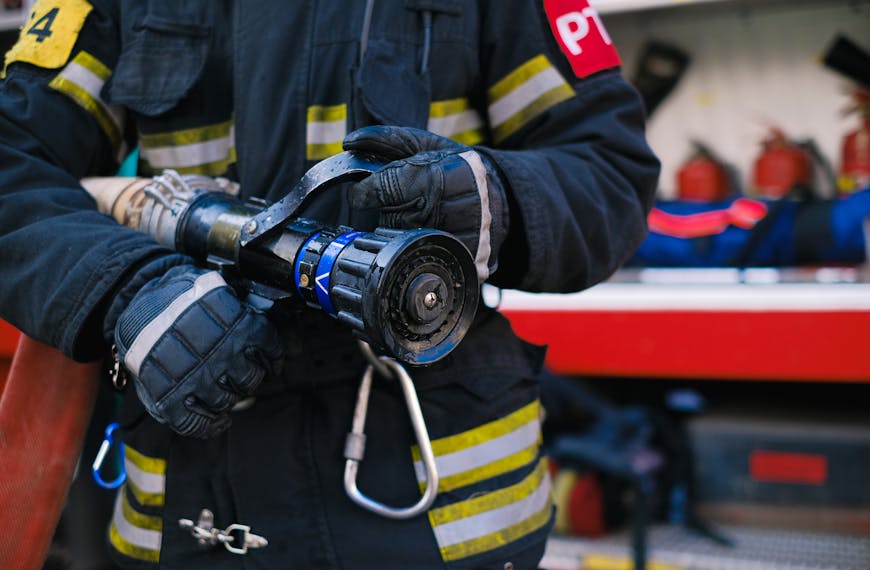 Close-up of a Firefighter Holding a Firehose
