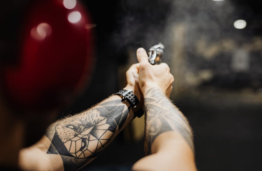 Hands of a Person Holding a Firearm