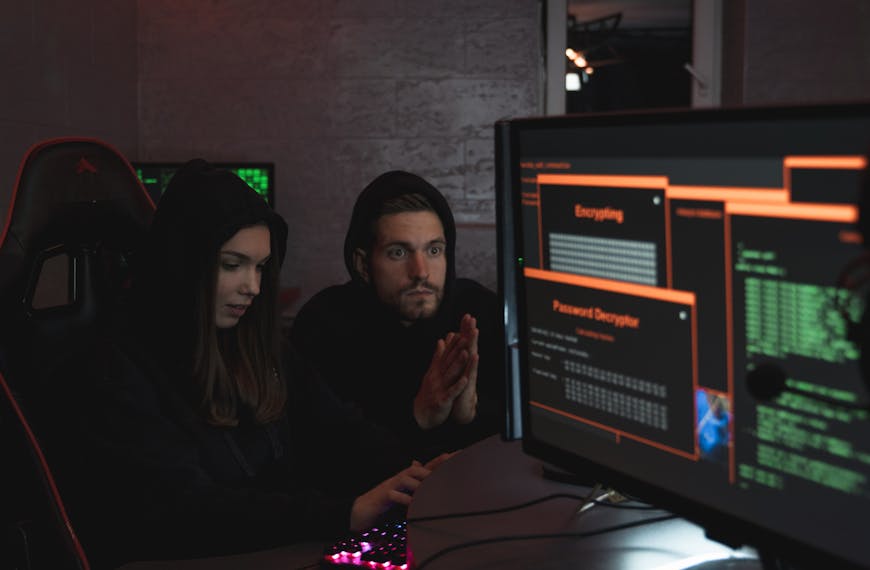 Man and Woman Hacking a Computer System
