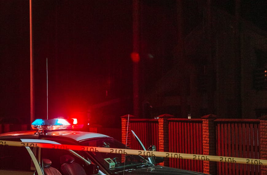 Police Car Behind Barricade Tapes