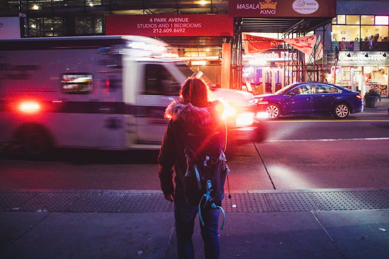 Back View of Woman Standing on Sidewalk