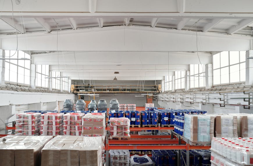 Spacious warehouse interior featuring organized shelves with various stacked pallets.